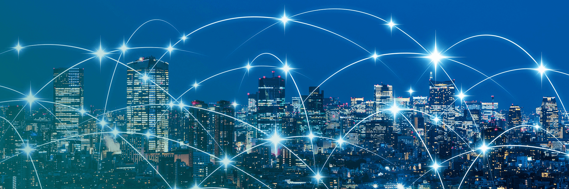 A photo of a city skyline at night overlaid with a graphic to imply wireless communication