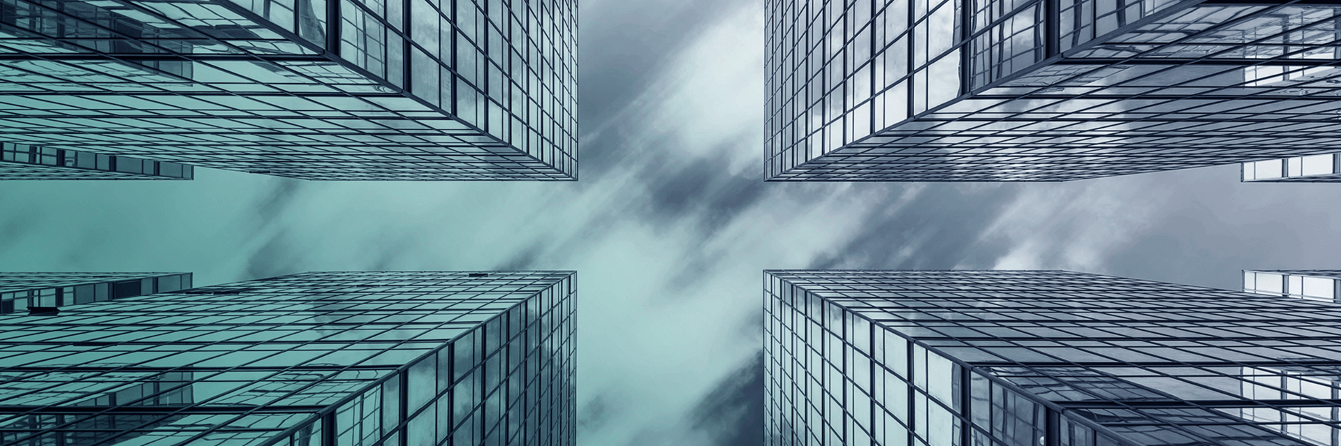 A photograph of the sky in between modern office buildings